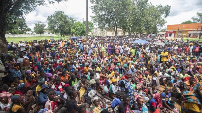 Displaced people from the province of Cabo Delgado gather to received humanitarian aid from the World Food Program in Namapa, Mozambique, February 27, 2024. 