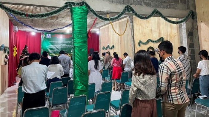 People worship during service inside a church in Jakarta