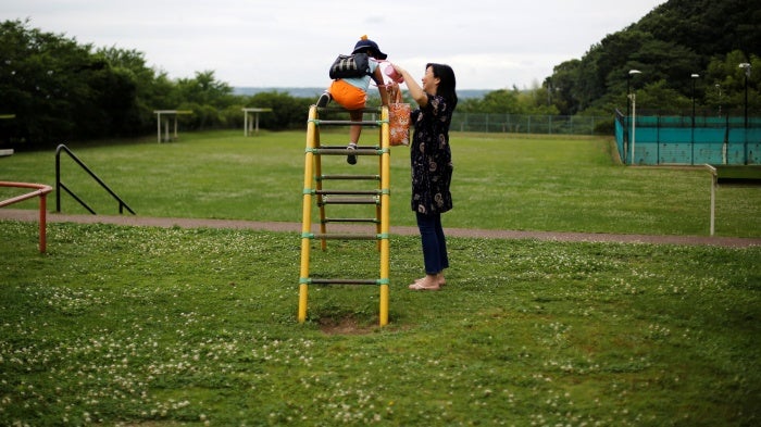 Foster mother Asako Yoshinari and her foster child at a park near her home in Inzai, Chiba prefecture, Japan, June 24, 2016.