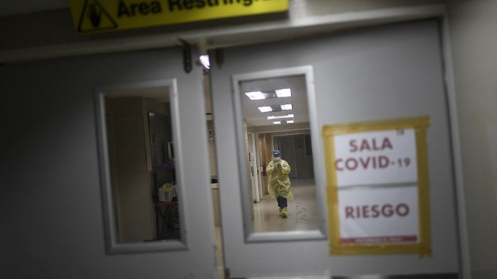 A health worker checks her smartphone.