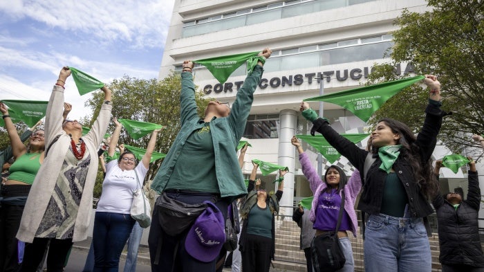 Women from different organizations that are part of the Justa Libertad movement raise green scarves outside the Constitutional Court of Ecuador in Quito, March 19, 2024.