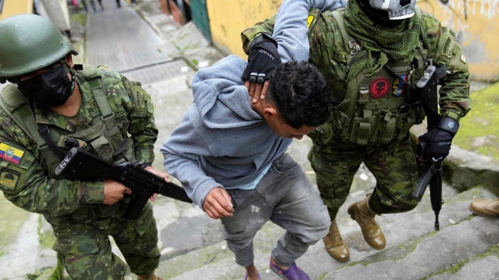 Soldiers briefly detain a youth to walk him to an area to check if he has gang-related tattoos as they patrol the south side of Quito, Ecuador, Friday January 12, 2024..