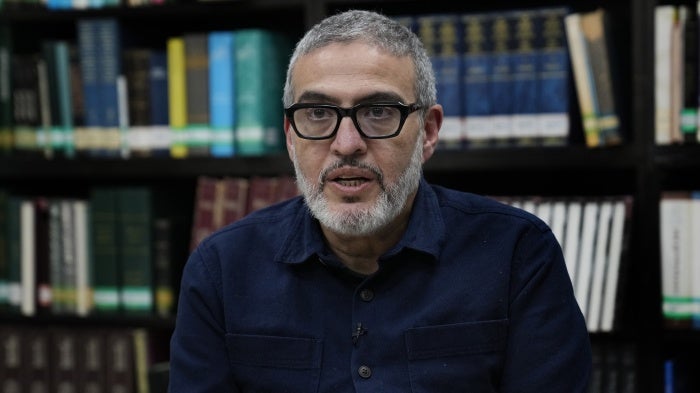 Dr. Ghassan Abu Sittah, a Palestinian-British plastic surgeon specializing in conflict medicine, speaks during an interview at the Institute for Palestine Studies in Beirut, Lebanon, December 9, 2023. © 2023 AP Photo/Hussein Malla