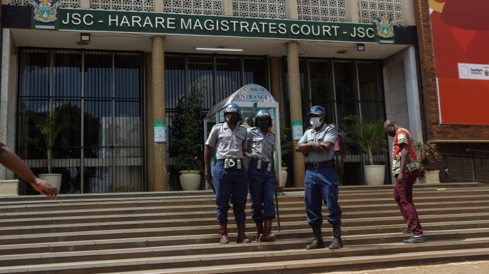 Police officers outside the Magistrates Court in Harare, Zimbabwe, April 6, 2021.