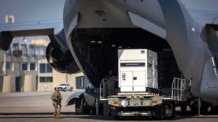 Supplies are offloaded from a U.S. Air Force C-17 cargo plane on the tarmac at Toussaint Louverture International Airport in Port-au-Prince, Haiti. The plane was carrying supplies for the camp being built for Kenyan police officers who will lead a Multinational Security Support mission into Haiti, May 15, 2024. 