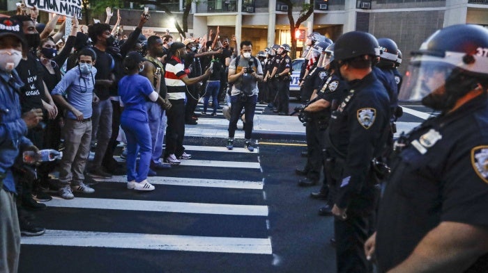 Protesters confront New York Police officers as part of a solidarity rally calling for justice over the death of George Floyd, in the Brooklyn, New York, June 3, 2020. 