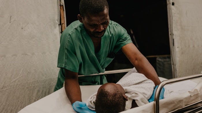 Medical staff at the ICRC-funded Ndosho hospital tend to a child injured from a 122mm rocket artillery strike on a displacement camp on the outskirts of Goma, North Kivu province, DR Congo, May 4, 2024.