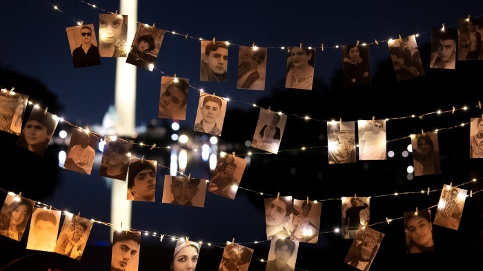 A display of photos that includes protesters executed by the Iranian government at a candlelight vigil honoring Mahsa Zhina Amini and the demonstrators, in Washington DC, September 16, 2023.
