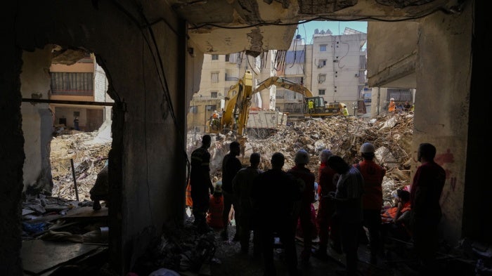 Emergency workers use excavators to clear the rubble at the site of an Israeli strike in Beirut’s southern suburbs, Lebanon, September 23, 2024