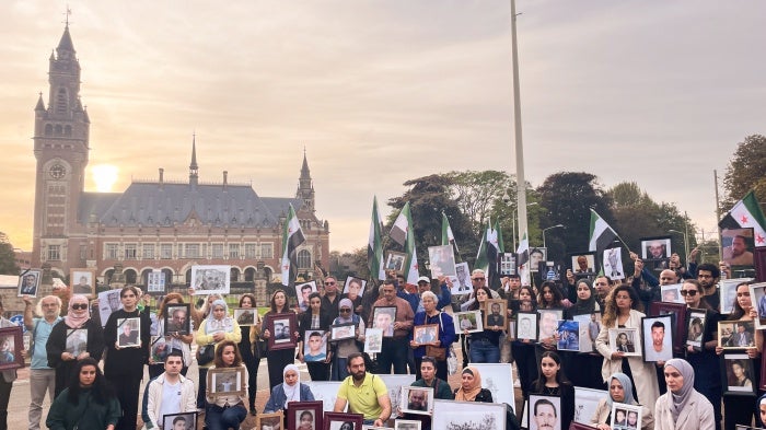 Relatives of Syrians who have been detained or disappeared protest in front of the International Court of Justice in The Hague, Netherlands, on October 10, 2023. 