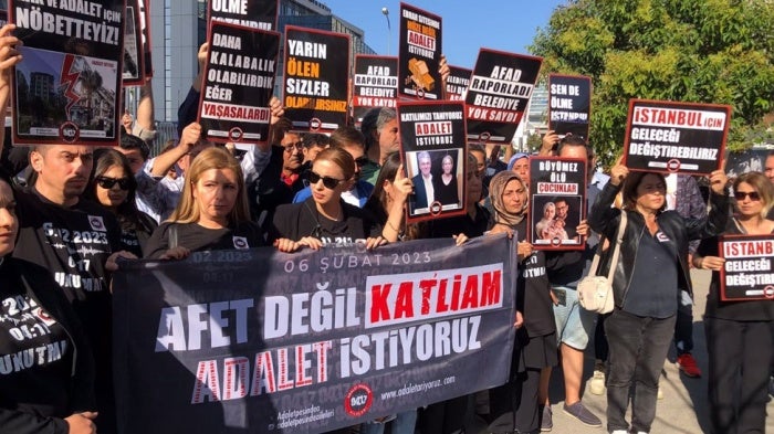 At an October 7, 2024 protest organized by the Families in Pursuit of Justice Platform, founded by those who lost their loved ones in the February 6, 2023 earthquakes, members hold a banner that reads, “Not a disaster but a massacre. We demand justice.”