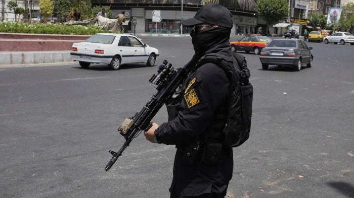 A member of Iran's security forces stands guard at Enqelab square in downtown Tehran, Iran, June 24, 2025.