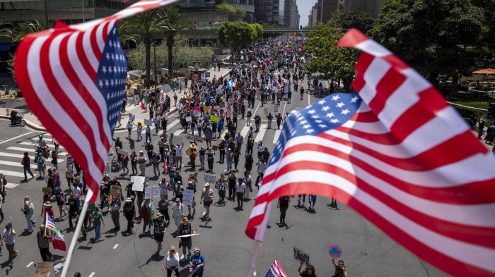 Demonstrators march during the "No Kings" national demonstration against US President Donald Trump and Immigration and Customs Enforcement in Los Angeles, California, June 14, 2025. 