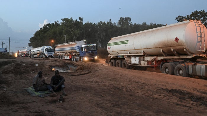Malian tanker trucks drive at the entrance of Boundiali, northern Côte d'Ivoire, on the way to Yamoussoukro and Abidjan to load oil, October 30, 2025.