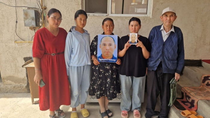 Family members and neighbor (far right) of Alimnur Turganbay, a Kazakhstan citizen detained in China, outside their house in Uzynagash village, located outside Almaty, Kazakhstan on August 4, 2025.