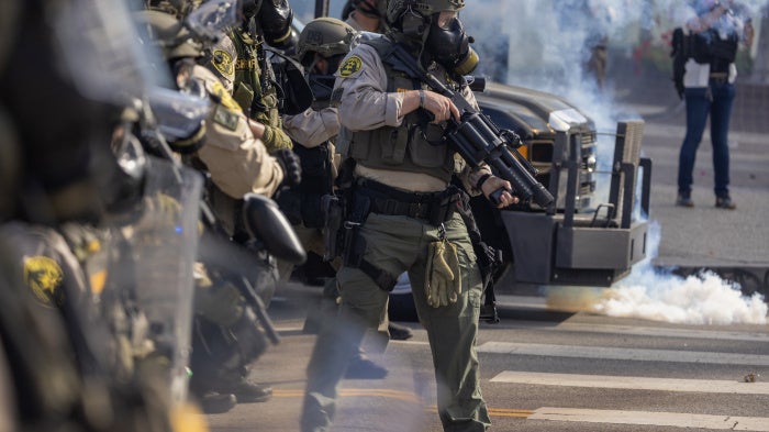 Sheriff deputies wield less-than-lethal munitions and tear gas during a "No Kings" protest in response to a series of federal immigration raids in Los Angeles, California, US, June 14, 2025. 