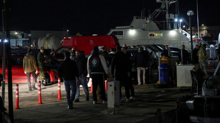 Greek emergency personnel wait to transfer bodies of dead migrants, following migrant's boat collision with coast guard off the island of Chios, in the port of Chios, Greece, February 3, 2026. 