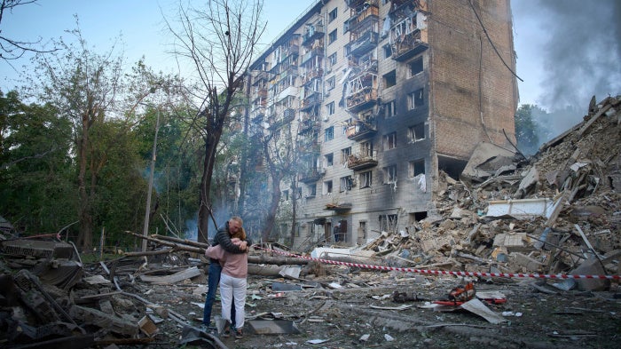 Residents react after a missile hit an apartment building during Russian attacks on Kyiv, Ukraine, June 17, 2025.