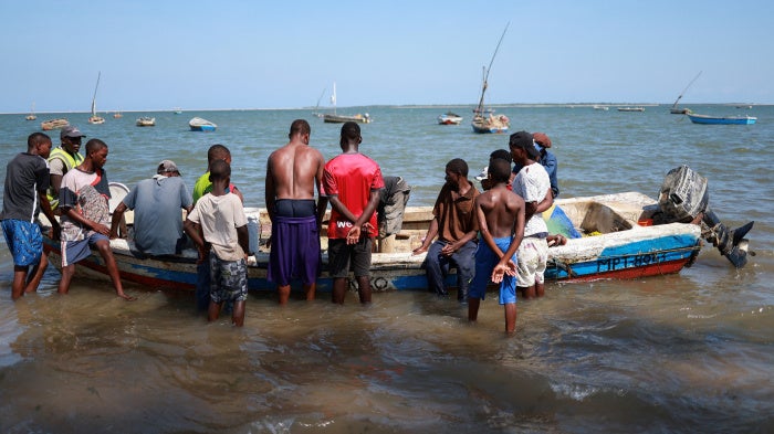 Fishermen sort their catch before carrying it to shore near the Costa do Sol fish market in Maputo, Mozambique, January 10, 2025.