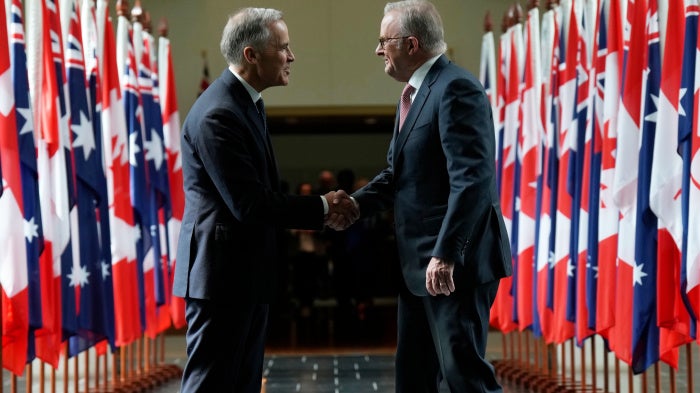 Canada's Prime Minister Mark Carney (left) and Australian Prime Minister Anthony Albanese as they leave Parliament following an address, in Canberra, Australia, March 5, 2026.