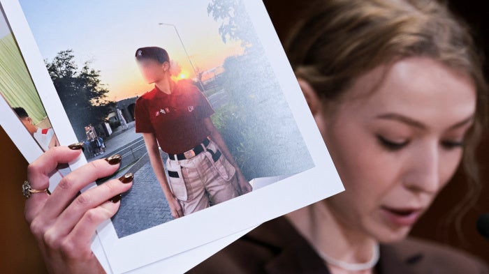 Kateryna Rashevska, a legal expert at the Regional Center for Human Rights (Kyiv, Ukraine), holds a picture she says depicts an abducted Ukrainian child, Washington DC, US, December 3, 2025.