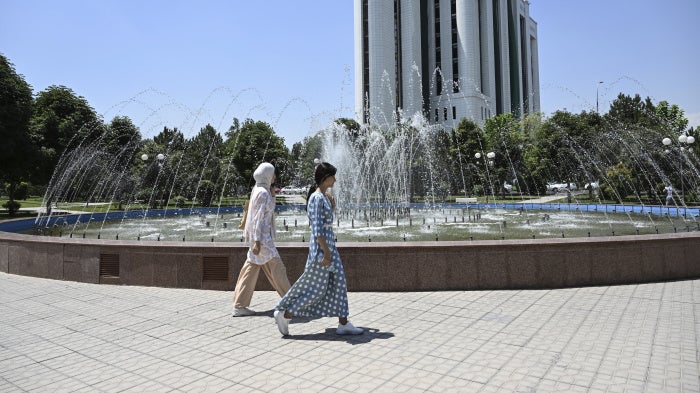 Women walk past a fountain in Tashkent, Uzbekistan, July 6, 2023.