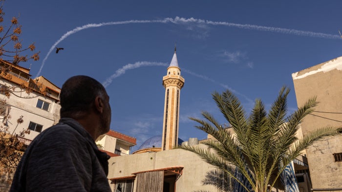 Contrails from Israeli fighter jets in the sky over Tyre, Lebanon, March 24, 2026.