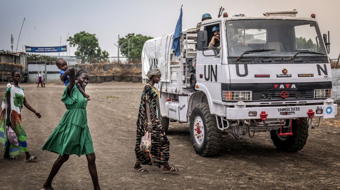 Residents react as they walk past a patrol truck operated by Indian peacekeepers serving with the United Nations Mission in South Sudan (UNMISS) in the strategic town of Akobo, Jonglei State, on February 12, 2026.