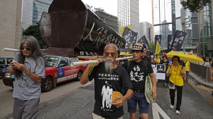 Koo Sze-yiu carries a coffin that reads, “The people’s heroes, they shall remain forever immortal" at a protest in Hong Kong, May 26, 2019