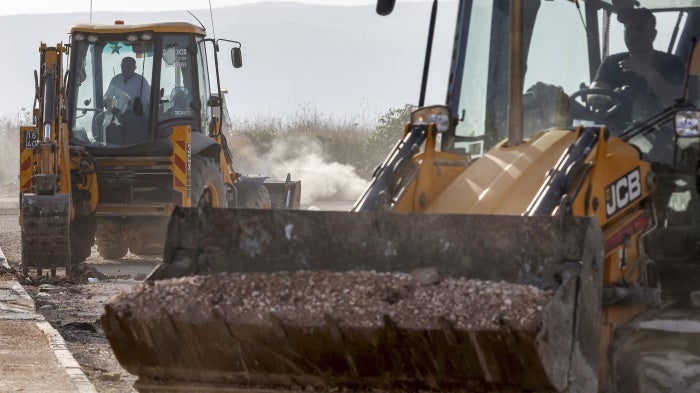 Bulldozers move during ongoing construction work at the settlement of Katzrin in the Israeli-annexed Golan Heights on December 17, 2024.