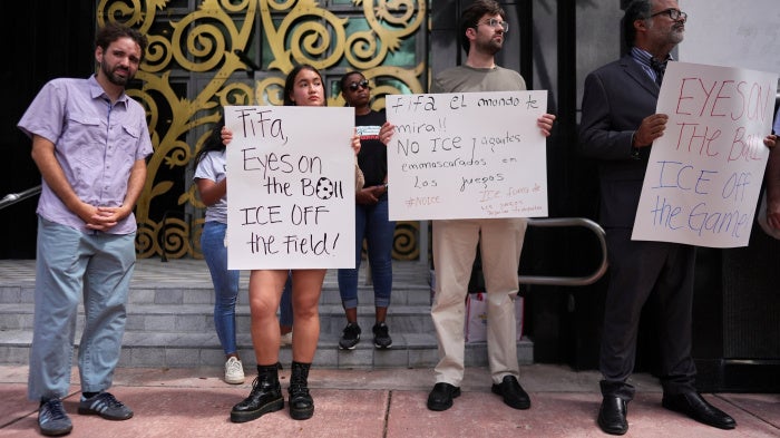 Protestors holding anti-ICE signs