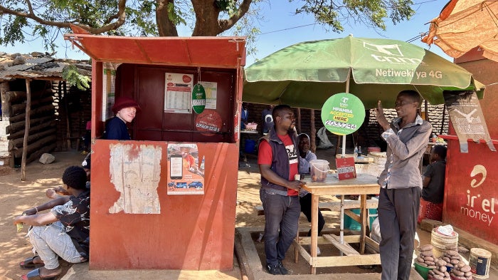 Maureen Kamatu, 28, has been self-employed at a mobile money cash-transfer booth in Lilongwe, Malawi. 