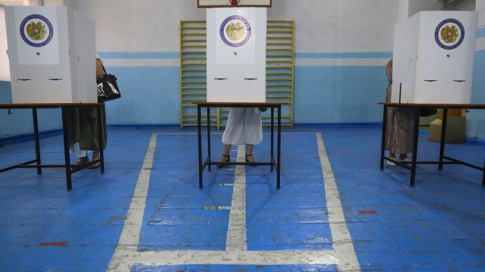 People at a polling station during a parliamentary election in Yerevan, Armenia, June 20, 2021.