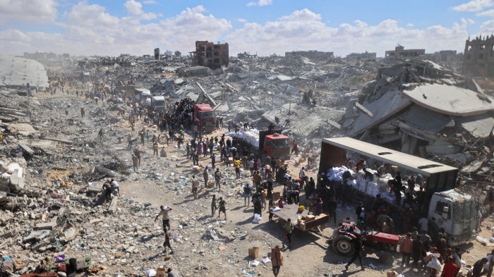 Aid trucks enter the Kerem Abu Salem crossing in Khan Younis, Gaza, October 12, 2025.