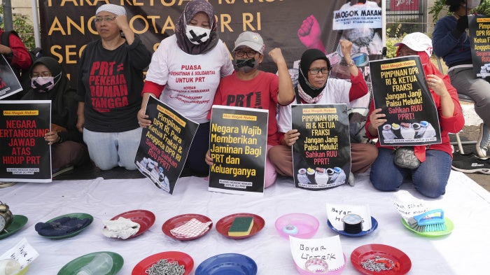 Activists demand the Indonesian parliament pass a bill to protect domestic workers outside the parliament building in Jakarta, August 14, 2023.