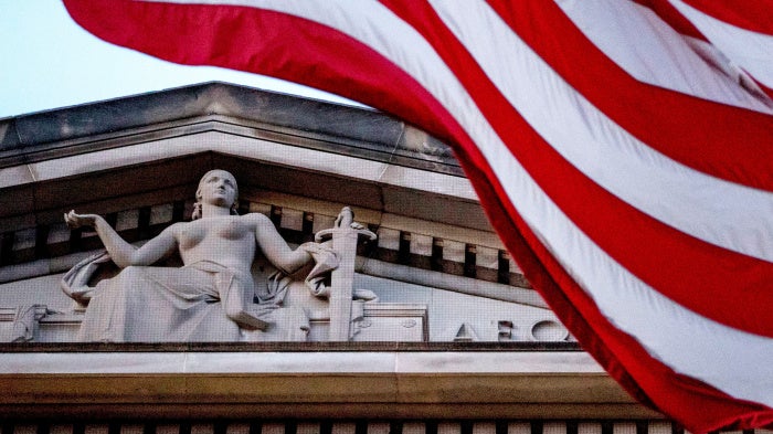 American flag flying outside Department of Justice