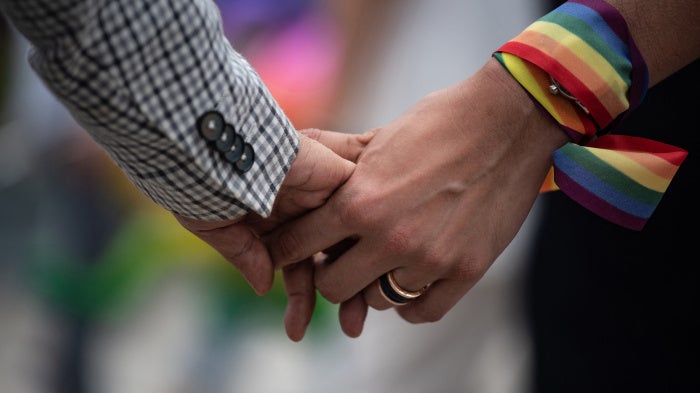 A same-sex couple hold hands during an event to raise awareness of gay rights in Hong Kong on May 25, 2019. 