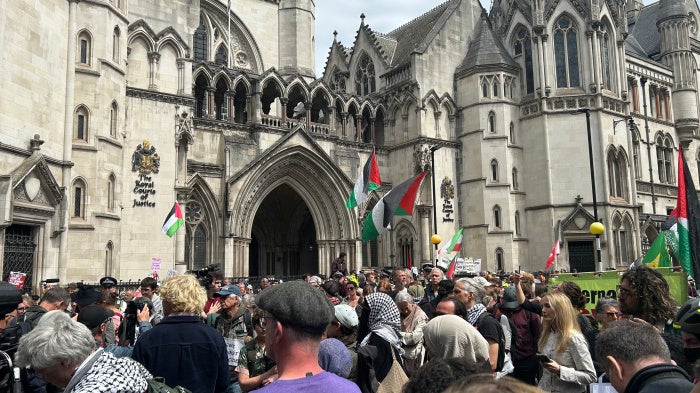 Protesters gather outside the Royal Courts of Justice on the Strand listening to the judge's statement, London, UK, June 15, 2026.