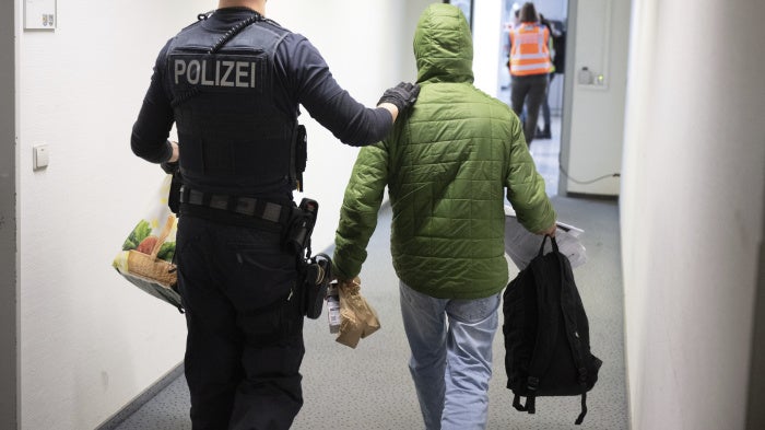 A German police officer takes a man to a deportation flight to Pakistan, February 25, 2025, Hesse, Germany.