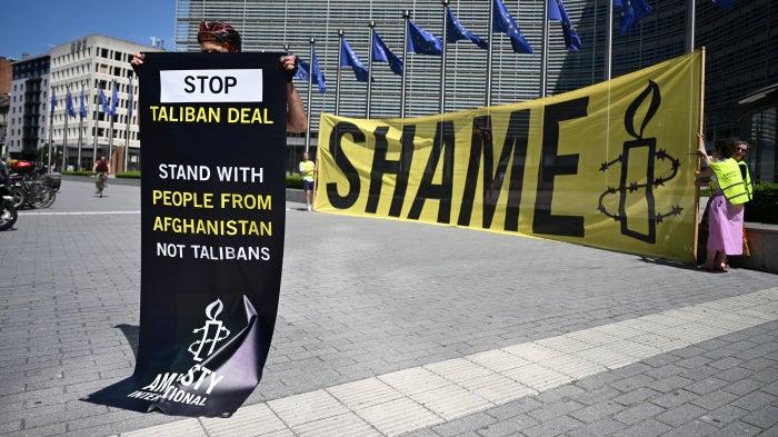 An activist at EU Commission headquarters protests against a meeting with a Taliban delegation in Brussels, Belgium, June 23, 2026.