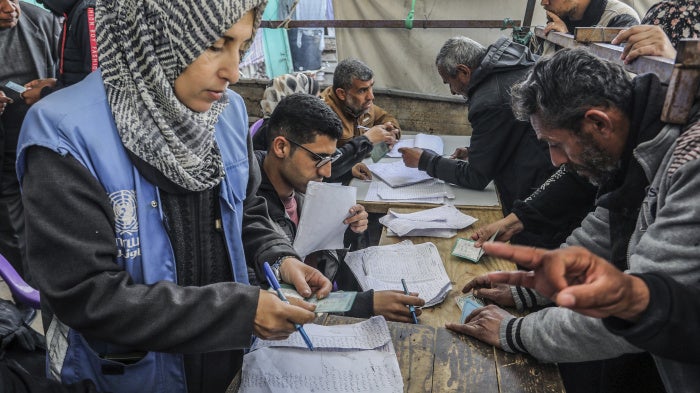 Palestinians receive humanitarian aid from the United Nations Relief and Works Agency for Palestine Refugees in the Near East (UNRWA) in Khan Younis, February 5, 2025. 