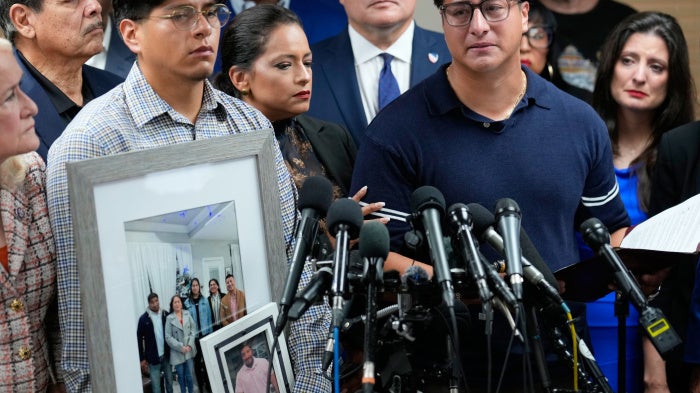 Ronaldo Salgado (right), son of Lorenzo Salgado Araujo, speaks as his brother, Lorenzo Jr. holds family photographs during a news conference in Houston, Texas, July 8, 2026.