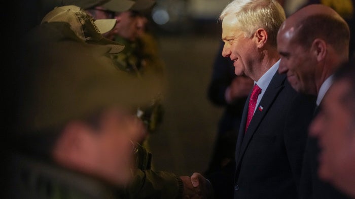 Chilean President José Antonio Kast greets police officers after announcing a new security agenda and stricter immigration enforcement, at the Plaza de Armas in Santiago, Chile, August 6, 2026. 