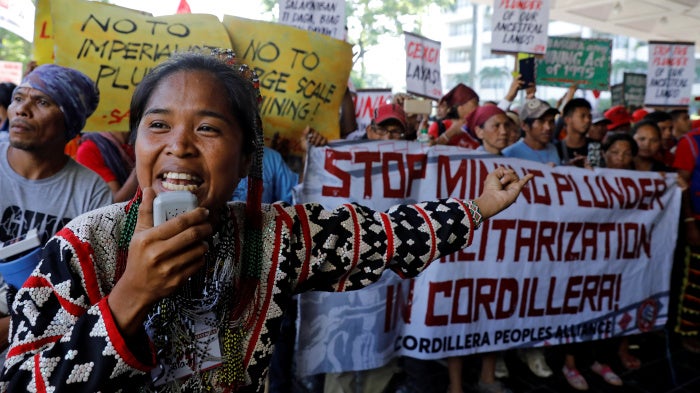 An anti-mining protester speaks during a rally outside the annual Philippines mining conference in Pasay, Metro Manila, September 6, 2017.