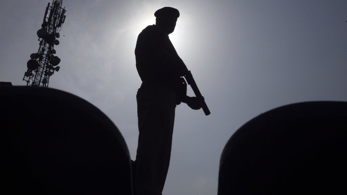 A police officer stands guard in Peshawar, Pakistan, August 5, 2023.