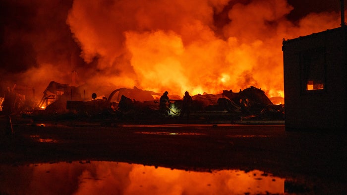 Firefighters put out a fire after Russian missiles hit a warehouse in Kyiv, Ukraine, on August 5, 2026. 