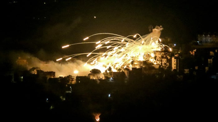 A white phosphorus munition airbursts over buildings in the town of Khiam in southern Lebanon during an Israeli bombardment on October 31, 2024.