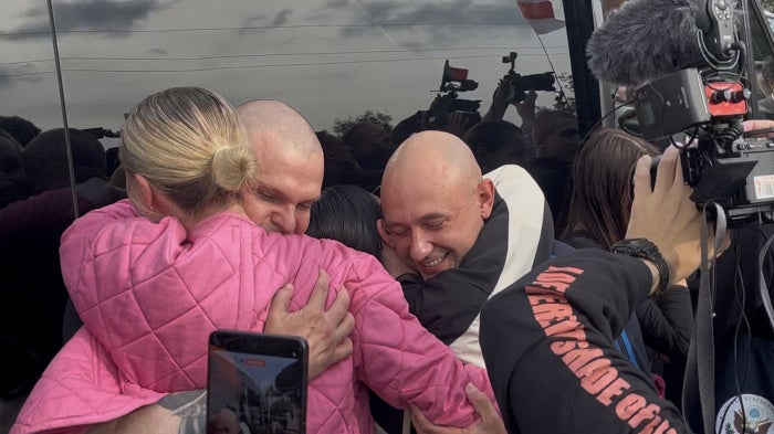 TOR BAND musicians, former political prisoners, embrace their loved ones after arriving in Vilnius on September 16, 2026.