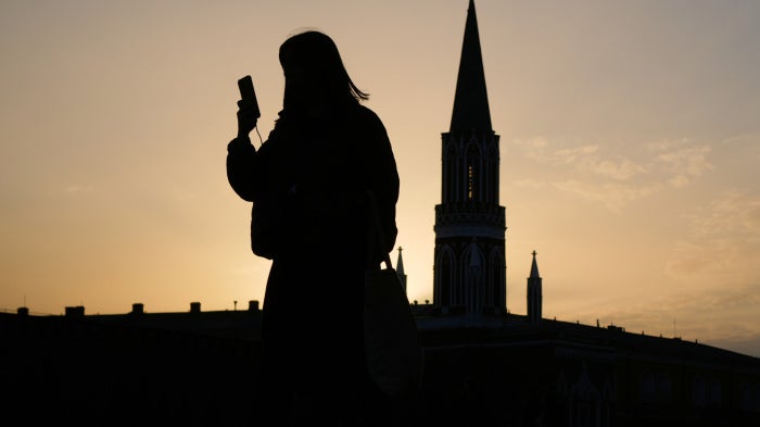  A person checks their phone in the Red Square in Moscow, Russia, March 31, 2026.