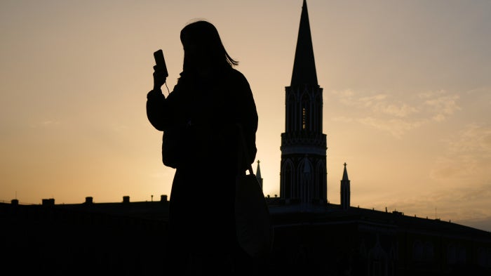  A person checks their phone in the Red Square in Moscow, Russia, March 31, 2026.